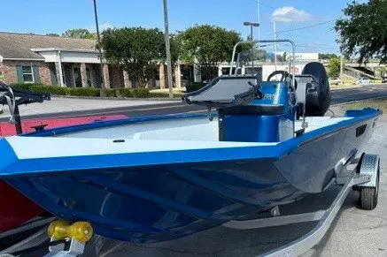 Slide: The Image of 2026 Sea Ark 19 Shadow CC boat on trailer, parked outdoors. - 2