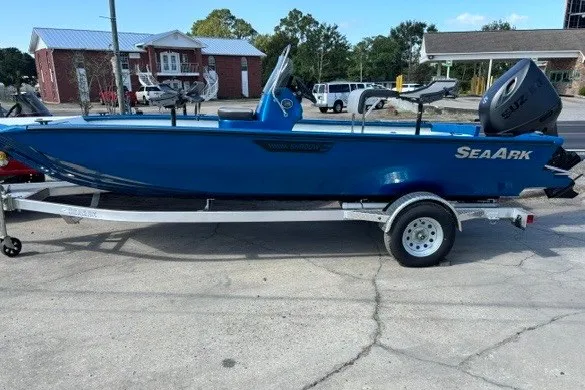 The Image of 2026 Sea Ark 19 Shadow CC boat on trailer, blue exterior, parked outdoors. - 1