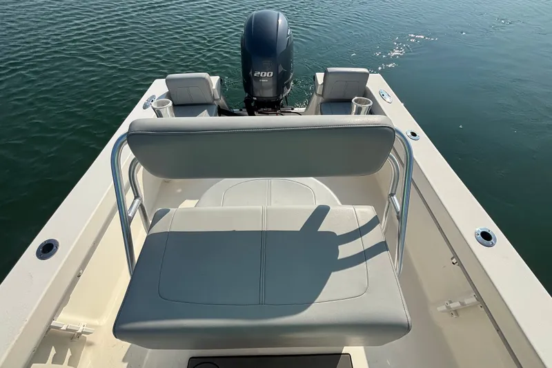 Slide: The Image of 2023 May-Craft 2300 CCX boat with seating and outboard motor on calm water. - 16
