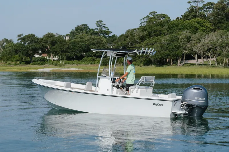 Slide: The Image of 2023 May-Craft 2300 CCX boat on calm water with Yamaha engine. - 18