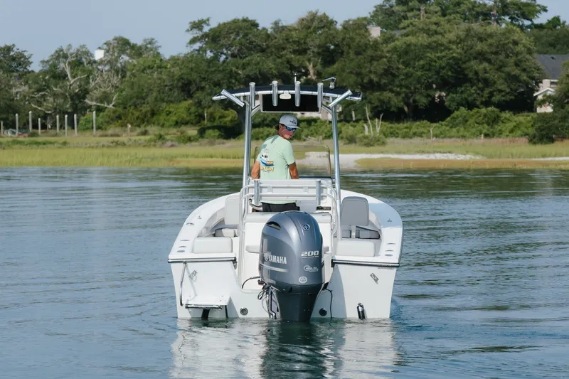 Slide: The Image of 2023 May-Craft 2300 CCX boat with Yamaha engine on calm water. - 13