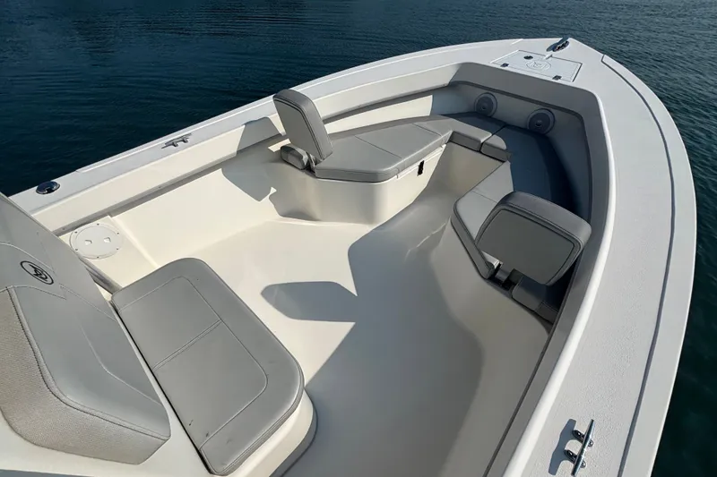 Slide: The Image of 2023 May-Craft 2300 CCX boat interior with cushioned seating and spacious deck. - 17