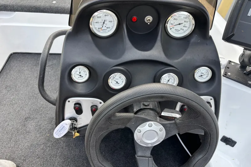 Slide: The Image of Dashboard of a 2004 Nitro NX 882 SC boat with steering wheel and gauges. - 11