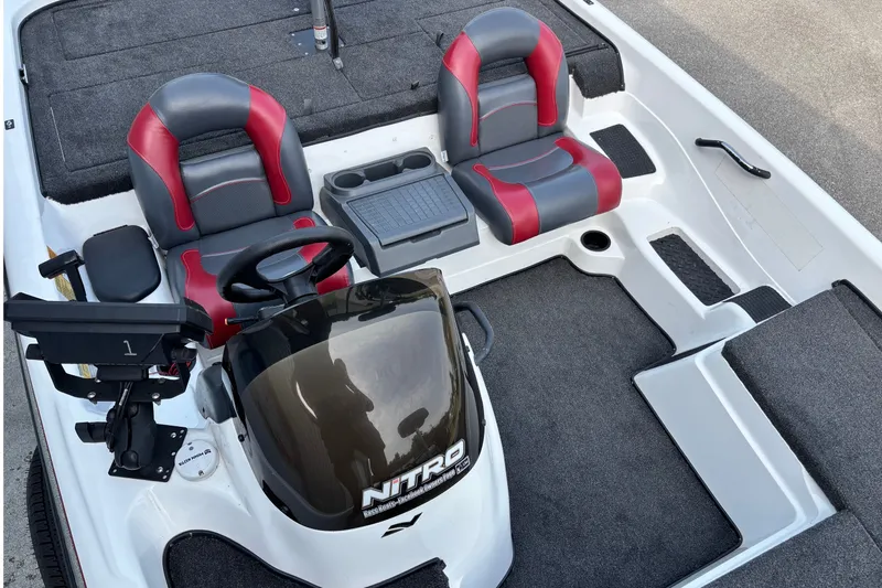 Slide: The Image of 2004 Nitro NX 882 SC boat interior with red and gray seating, steering console, and carpeted deck. - 10