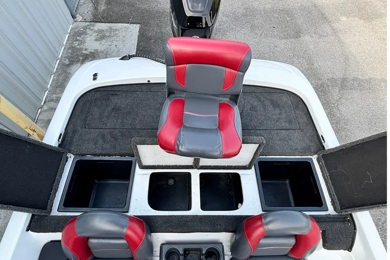 Slide: The Image of 2004 Nitro NX 882 SC boat interior with red and gray seating and storage compartments. - 16