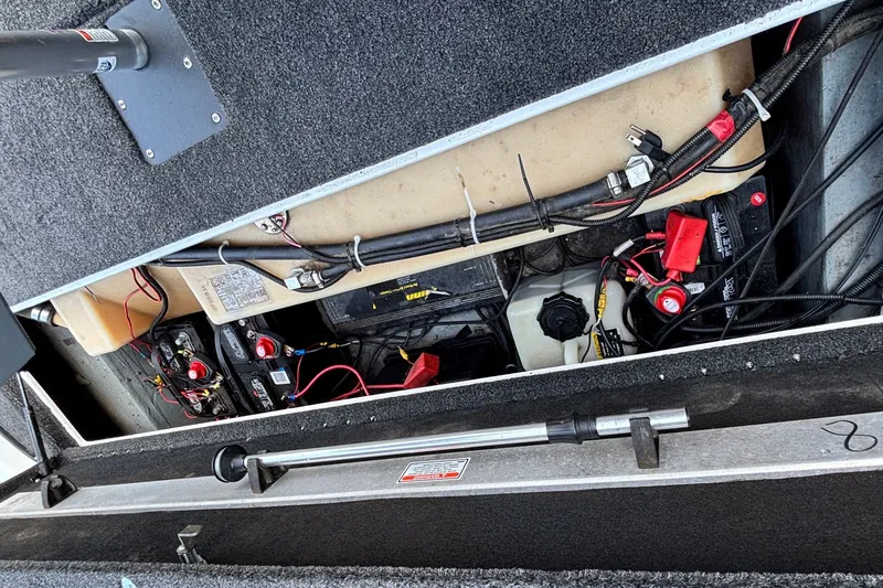 Slide: The Image of 2004 Nitro NX 882 SC boat battery compartment with wiring and components. - 17