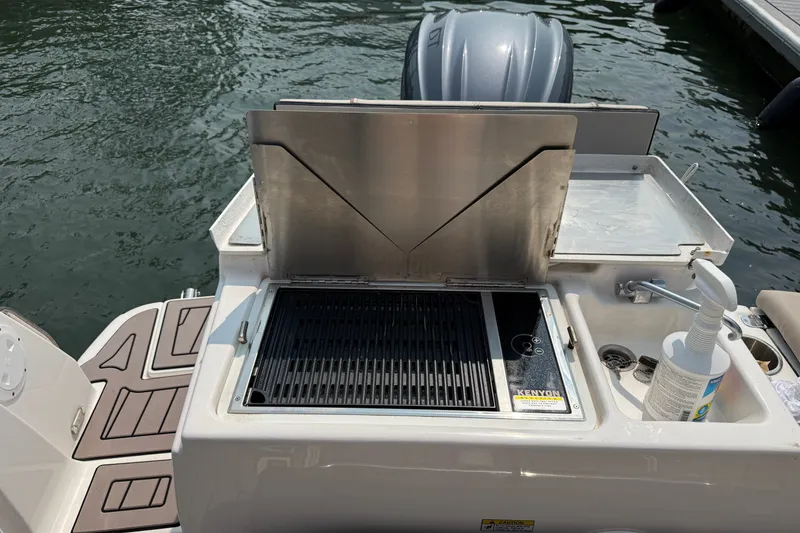 Slide: The Image of Outdoor grill and sink on 2024 Cutwater C-248 Coupe boat, docked by the water. - 29