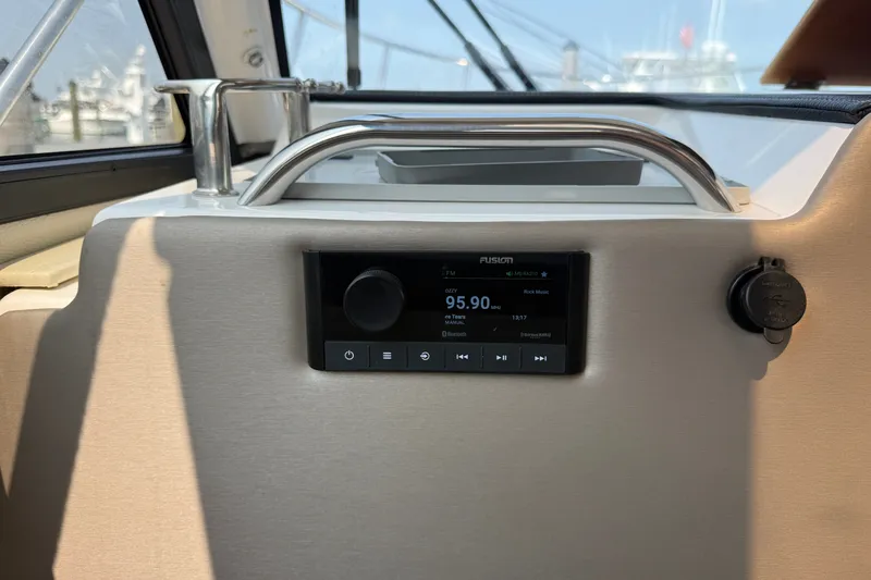 Slide: The Image of 2024 Cutwater C-248 Coupe interior with Fusion stereo system displaying FM radio station. - 17