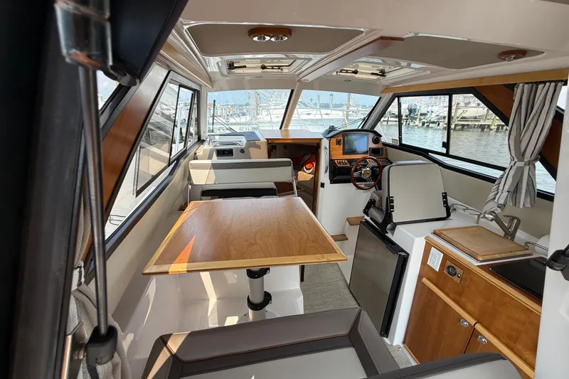 Slide: The Image of Interior of 2024 Cutwater C-248 Coupe boat with dining area and helm station. - 38