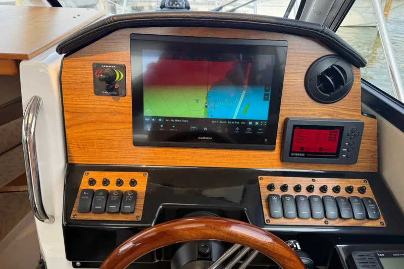 Slide: The Image of 2024 Cutwater C-248 Coupe helm with Garmin navigation display and control panel. - 16