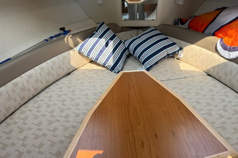Slide: The Image of 2024 Cutwater C-248 Coupe interior with striped pillows and patterned seating. - 19