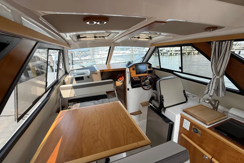 Slide: The Image of Interior of 2024 Cutwater C-248 Coupe boat with modern helm and seating area. - 37