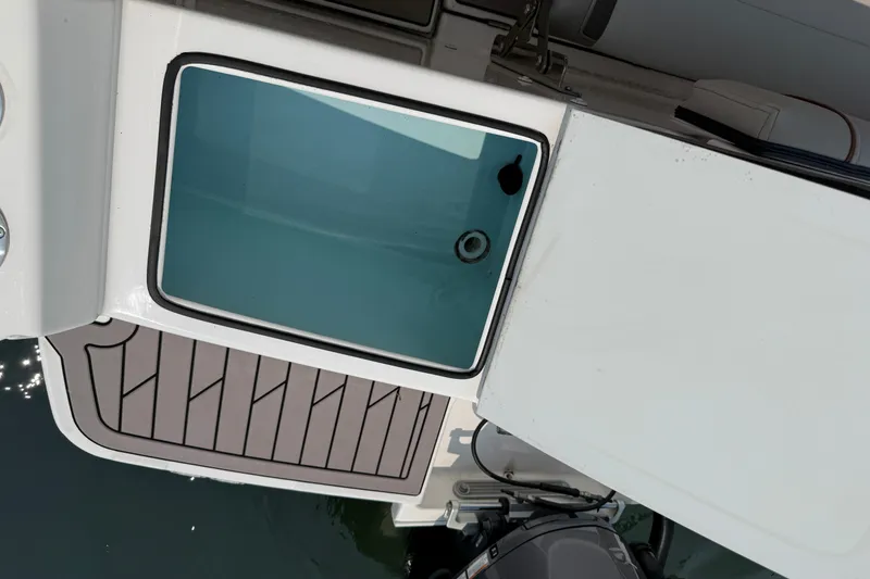 Slide: The Image of 2024 Cutwater C-248 Coupe boat deck with storage compartment and motor. - 32
