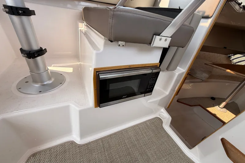 Slide: The Image of 2024 Cutwater C-248 Coupe interior with microwave and seating area. - 26