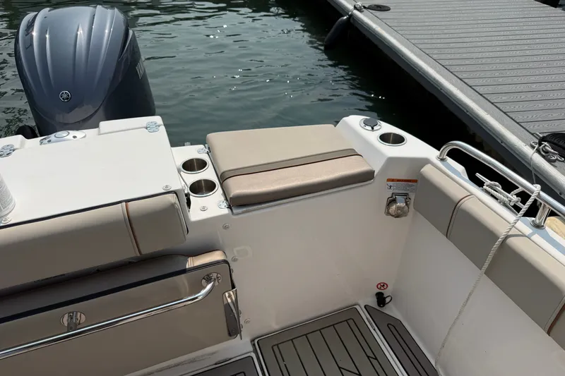 Slide: The Image of 2024 Cutwater C-248 Coupe boat interior with seating, cup holders, and outboard motor. - 30