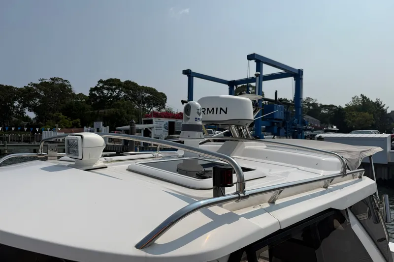 Slide: The Image of 2024 Cutwater C-248 Coupe boat with Garmin radar on the roof at a marina. - 14