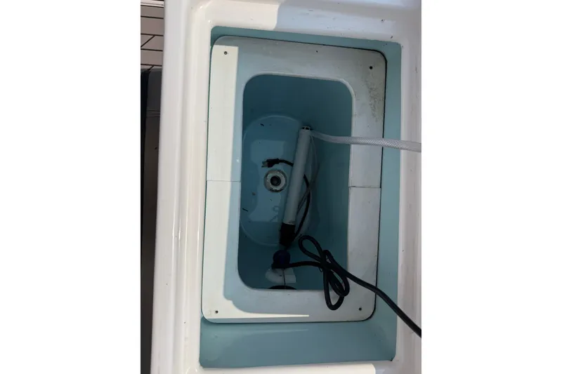 Slide: The Image of 2024 Cutwater C-248 Coupe boat compartment with pump and hose. - 27