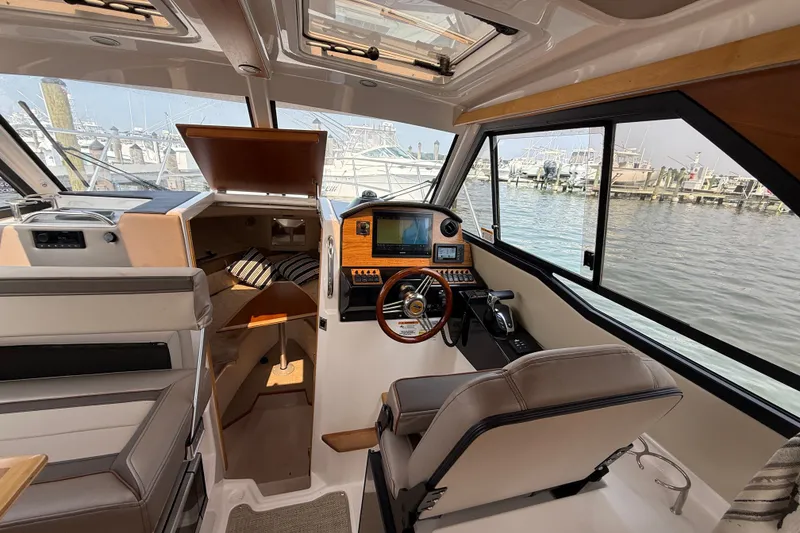 Slide: The Image of 2024 Cutwater C-248 Coupe interior with helm, seating, and cabin view. - 21
