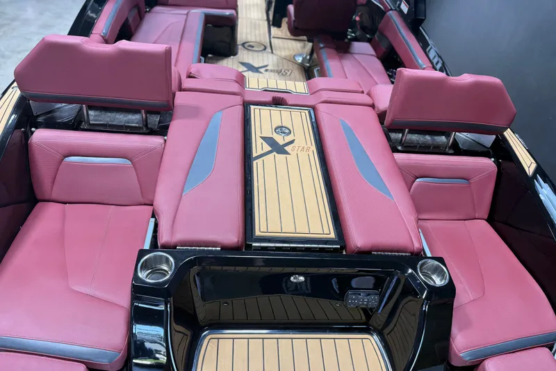 Slide: The Image of 2023 MasterCraft XStar S interior with luxurious red seating and sleek design. - 18