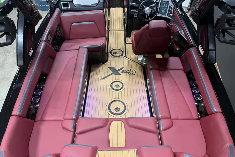 Slide: The Image of Luxurious interior of 2023 MasterCraft XStar S boat with red seating and sleek dashboard. - 16