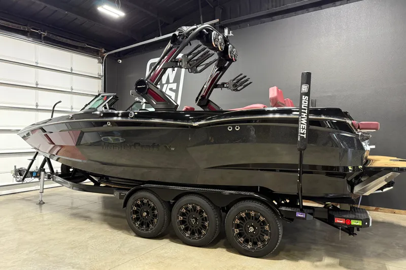 Slide: The Image of 2023 MasterCraft XStar S boat on trailer in indoor showroom. - 22