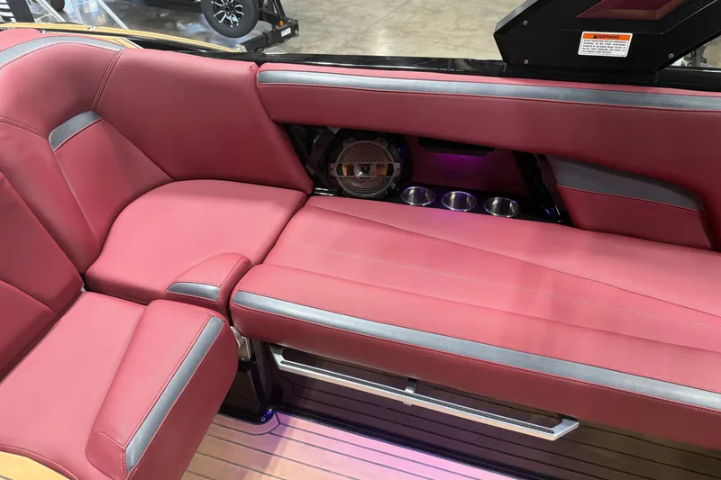 Slide: The Image of 2023 MasterCraft XStar S interior with red seating, cup holders, and speaker system. - 14