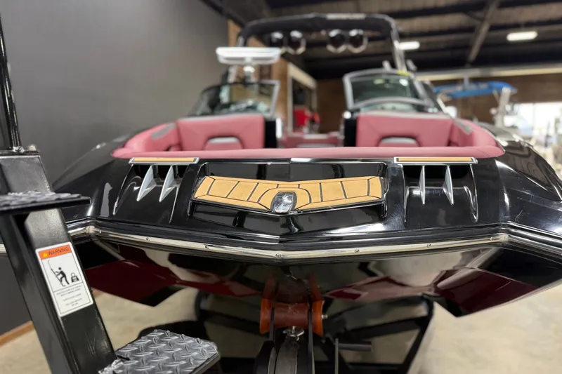 Slide: The Image of 2023 MasterCraft XStar S boat with sleek black design and red interior. - 21