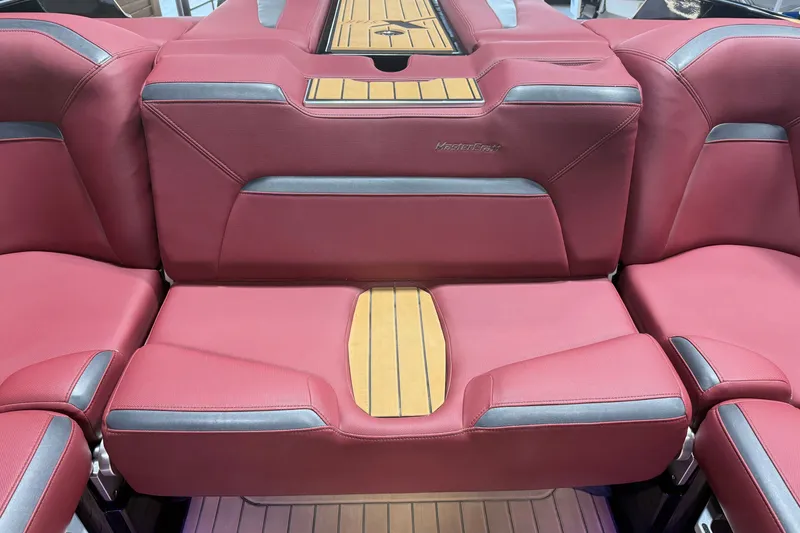 Slide: The Image of 2023 MasterCraft XStar S interior with red upholstery and wood accents. - 13