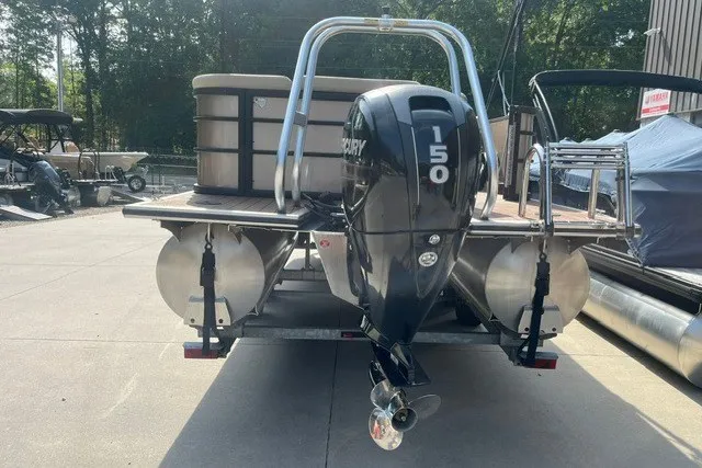 Slide: The Image of 2023 Bentley Pontoons Legacy 243 Cruise with Mercury 150 engine, parked outdoors. - 3