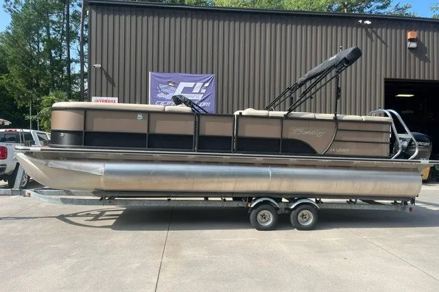 Slide: The Image of 2023 Bentley Pontoons Legacy 243 Cruise on trailer outside a warehouse. - 1