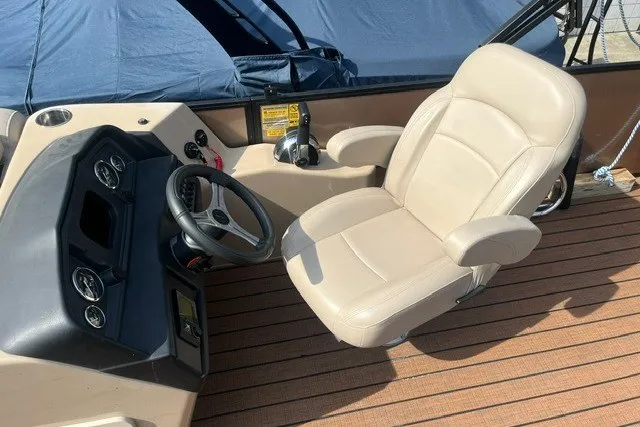 Slide: The Image of Captain's chair and helm of 2023 Bentley Pontoons Legacy 243 Cruise boat. - 9