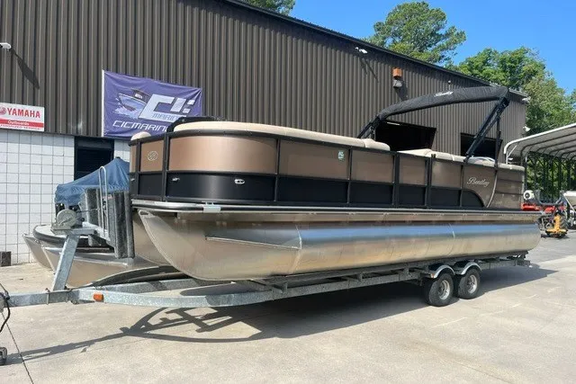 The Image of 2023 Bentley Pontoons Legacy 243 Cruise on trailer, parked outside a building. - 0