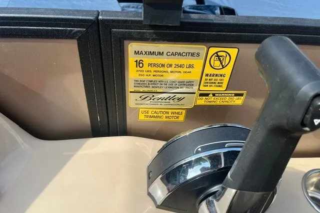 Slide: The Image of Bentley Pontoons Legacy 243 Cruise 2023 dashboard with capacity warning labels. - 13