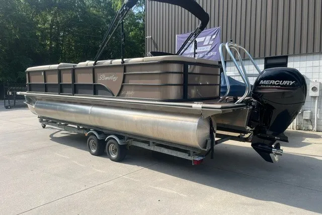 Slide: The Image of 2023 Bentley Pontoons Legacy 243 Cruise on trailer with Mercury outboard motor. - 2