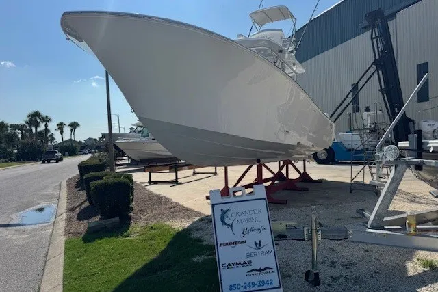 Slide: The Image of 2020 Front Runner 39 Center Console boat displayed outdoors near a marina. - 1