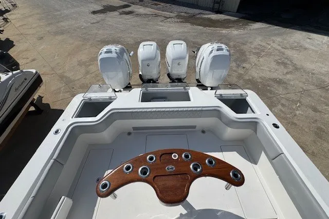Slide: The Image of 2020 Front Runner 39 Center Console boat with triple outboard engines and wooden helm. - 25