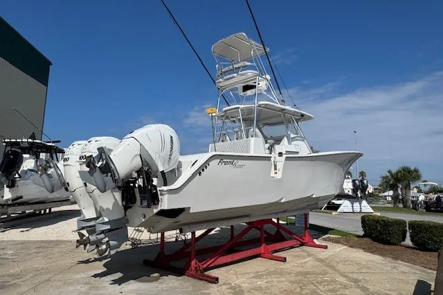 Slide: The Image of 2020 Front Runner 39 Center Console boat on display with triple outboard engines. - 3