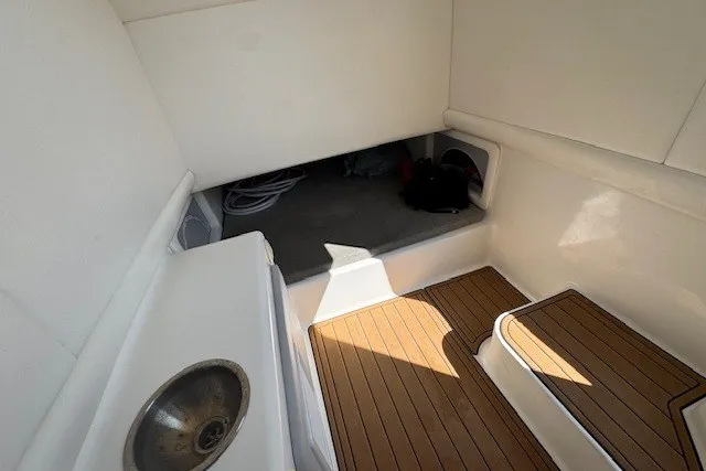 Slide: The Image of Interior view of 2020 Front Runner 39 Center Console boat with wood flooring and sink. - 22