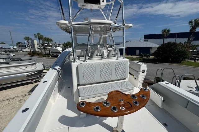 Slide: The Image of 2020 Front Runner 39 Center Console boat with seating and rod holders, docked outdoors. - 17