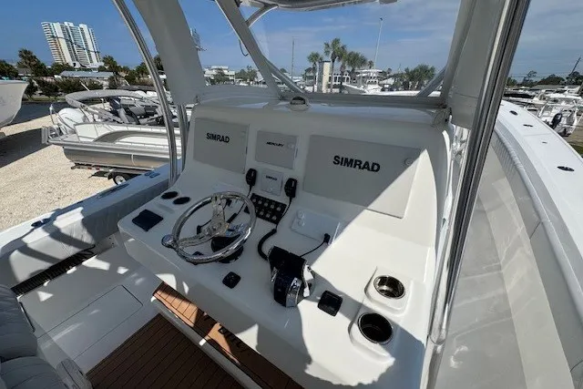 Slide: The Image of 2020 Front Runner 39 Center Console boat dashboard with Simrad electronics in marina setting. - 21