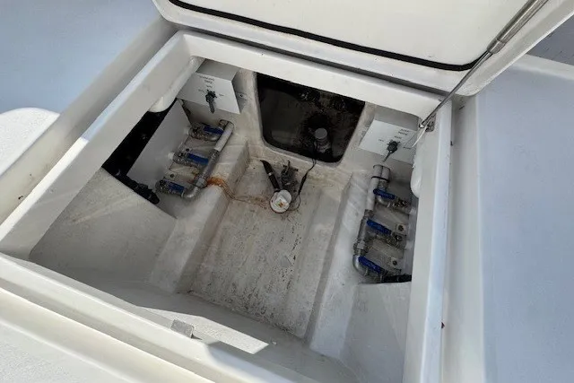 Slide: The Image of 2020 Front Runner 39 Center Console boat storage compartment with visible plumbing and anchor. - 16