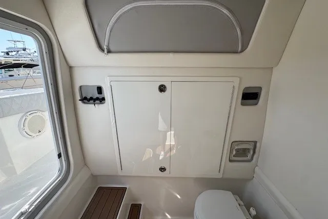 Slide: The Image of Interior of 2020 Front Runner 39 Center Console boat, featuring a compact bathroom area. - 24