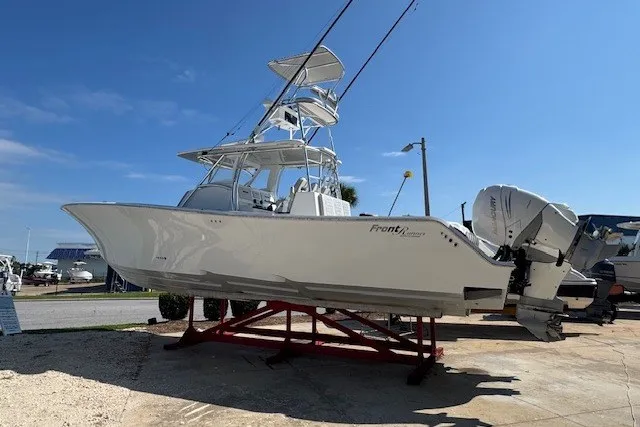 Slide: The Image of 2020 Front Runner 39 Center Console boat on display, elevated on a stand. - 2