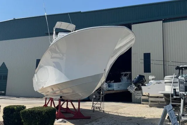 Slide: The Image of 2020 Front Runner 39 Center Console boat on stands outside a large warehouse. - 4