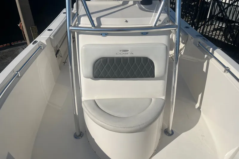 Slide: The Image of 2024 Cobia 237 Center Console boat interior with cushioned seating and stainless steel railings. - 8