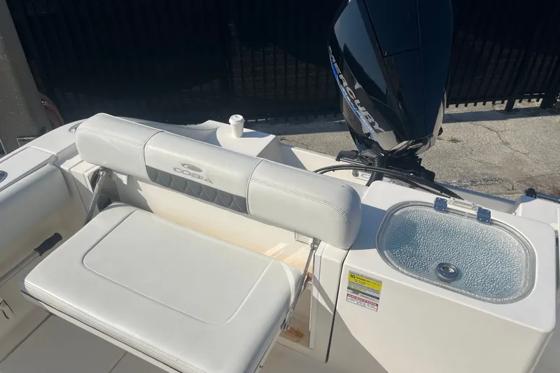 Slide: The Image of 2024 Cobia 237 Center Console boat with Mercury engine and seating area. - 7