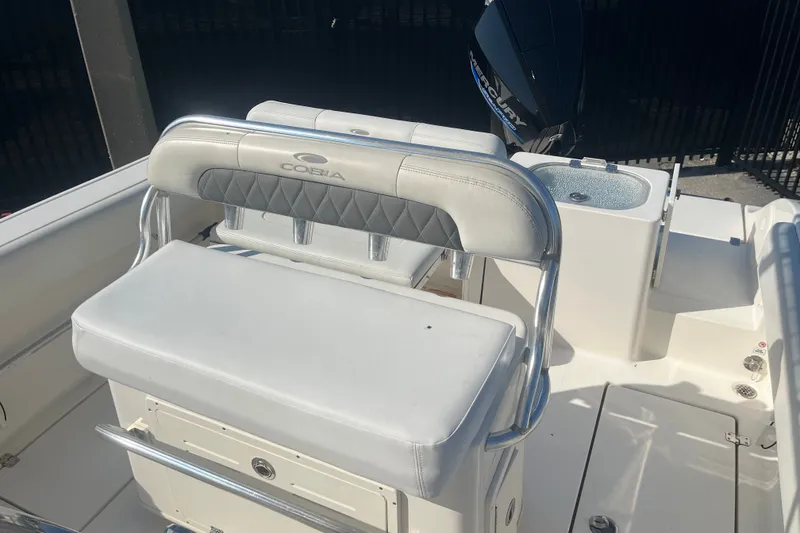 Slide: The Image of 2024 Cobia 237 Center Console boat interior with seating and motor. - 9
