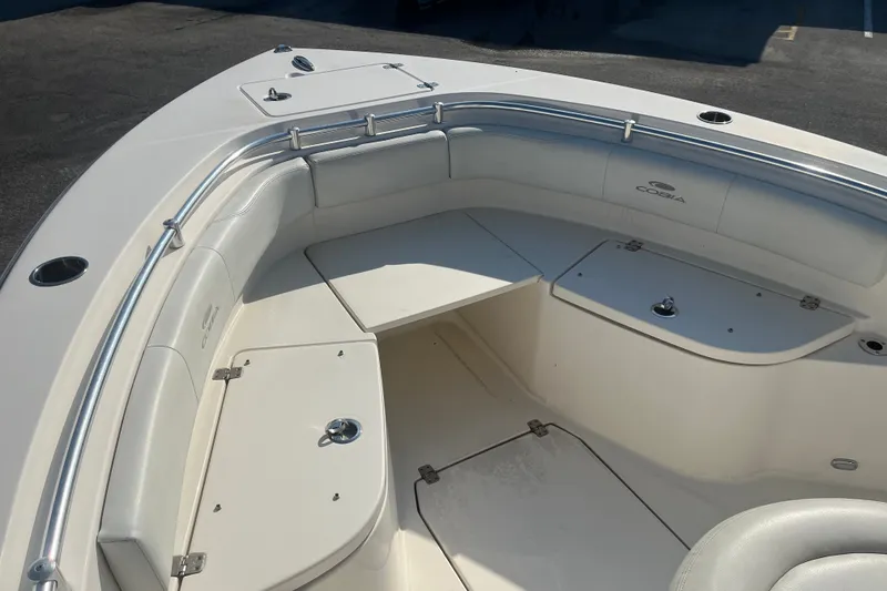 Slide: The Image of 2024 Cobia 237 Center Console boat interior with cushioned seating and storage compartments. - 10