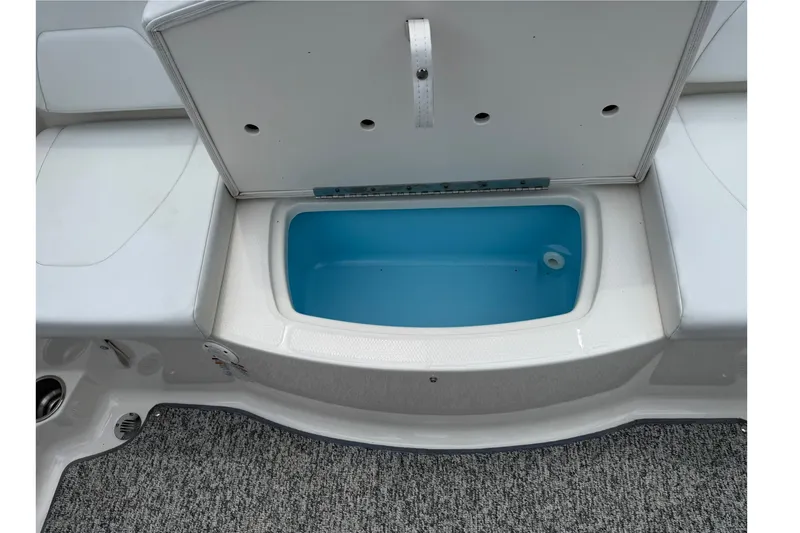 Slide: The Image of Open storage compartment on a 2014 Chaparral 19 Sport H2O boat. - 13