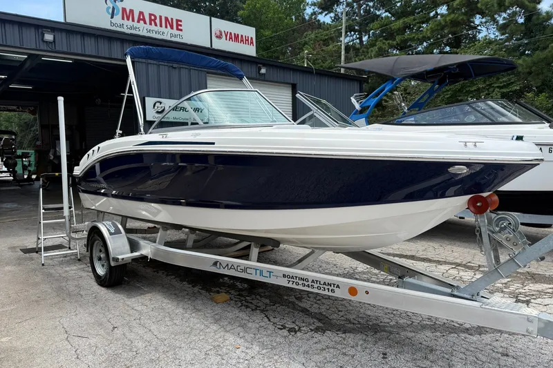 The Image of 2014 Chaparral 19 Sport H2O boat on trailer at marine service center. - 0